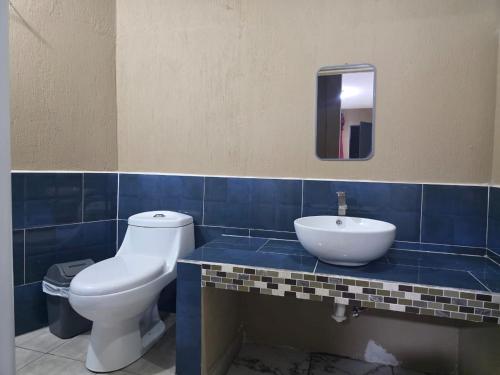 a bathroom with a toilet and a sink at Xelaju Hotel in Quetzaltenango