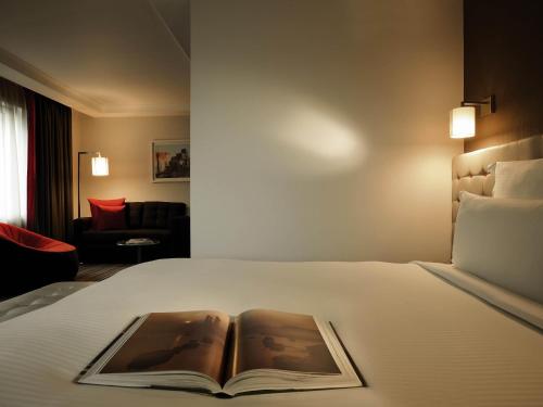 a book sitting on top of a bed at Pullman London St Pancras in London