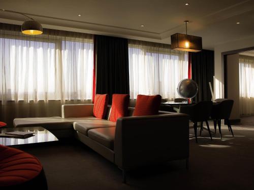 a living room with a couch with red pillows at Pullman London St Pancras in London
