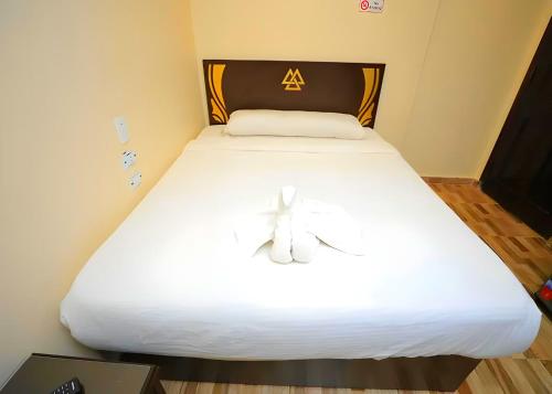 a white bed with a bow on top of it at Pyramids Sphinx VIEW Hotel in Cairo