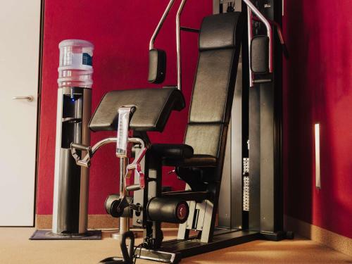 a treadmill in a gym with a bench at Mercure Grand Hotel Biedermeier Wien in Vienna