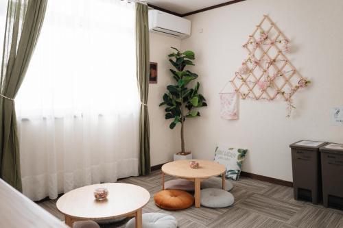 a room with two tables and a star decoration on the wall at 雪场缆车站旁-汤泽雪の宿-Ski IN Ski OUT-全新装修 in Seki