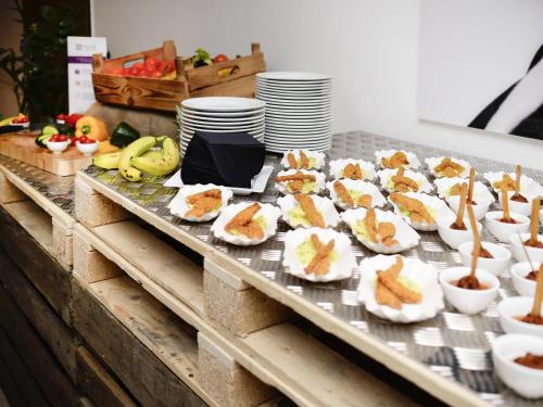 a buffet with appetizers and fruit on a table at Hotel Mercure Wien Westbahnhof in Vienna