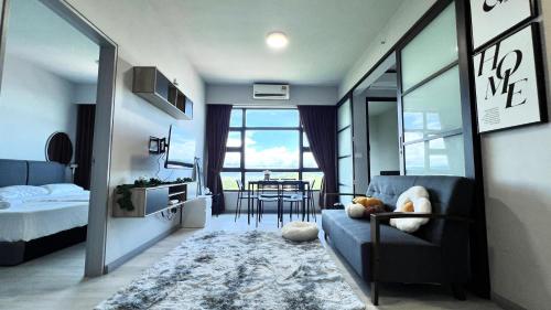 a bedroom with a couch and a table in a room at JQ 合一民宿3 Unity Homestay 3 City Seaview 5pax in Kota Kinabalu
