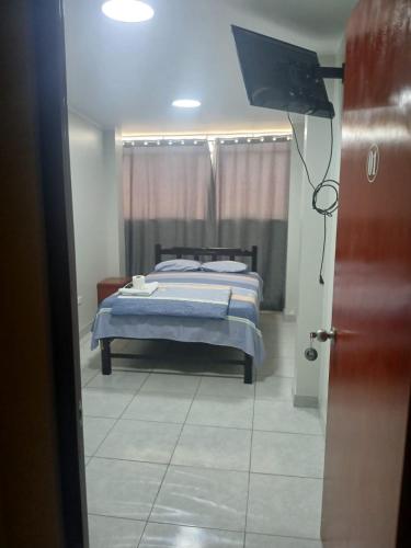 Ένα ή περισσότερα κρεβάτια σε δωμάτιο στο Hotel Magu Huarmey