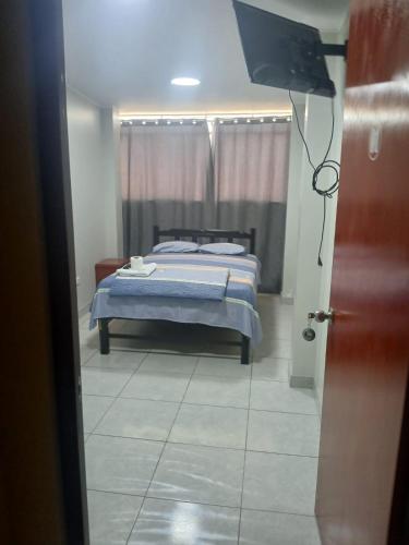 Ένα ή περισσότερα κρεβάτια σε δωμάτιο στο Hotel Magu Huarmey