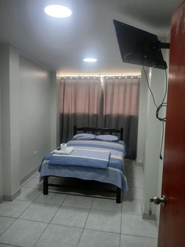 Ένα ή περισσότερα κρεβάτια σε δωμάτιο στο Hotel Magu Huarmey