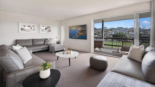 a living room with a couch and a table at Surf N Turf in Kiama