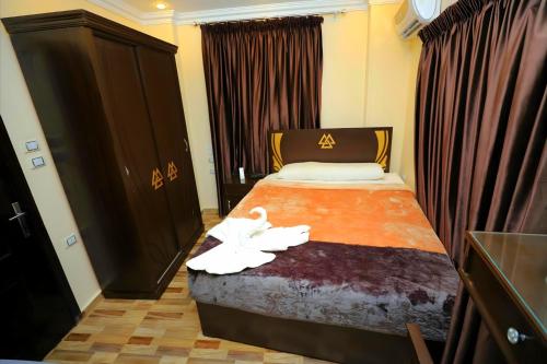 a hotel room with a bed with a flower on it at Pyramids Sphinx VIEW Hotel in Cairo