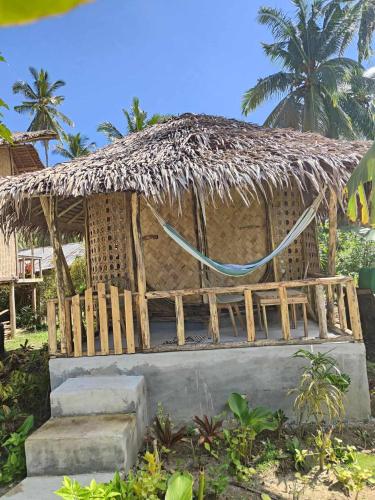 a small hut with a thatched roof at Prince John Beachfront Eco Bungalows and Restaurant in San Vicente