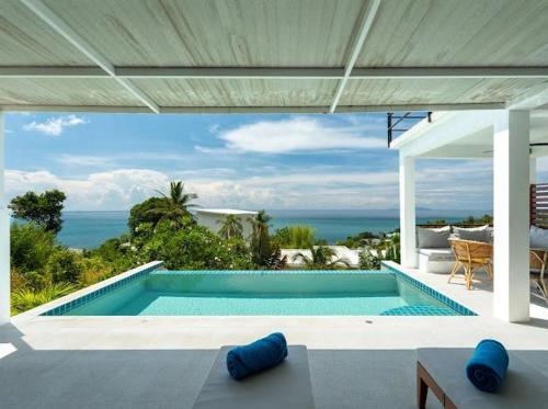 a swimming pool with a view of the ocean at Tahiana Villa in Haad Tian