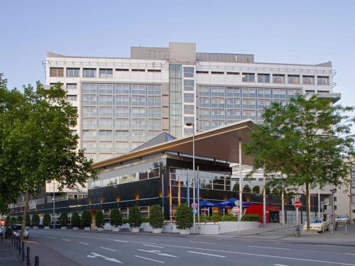 a large building on the side of a street at Pullman Cologne in Cologne