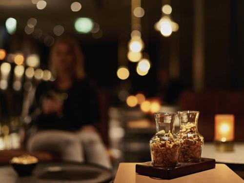 a group of snacks in a glass vase on a table at Pullman Cologne in Cologne