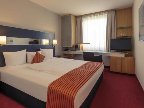 Ένα ή περισσότερα κρεβάτια σε δωμάτιο στο Mercure Hotel Düsseldorf City Nord