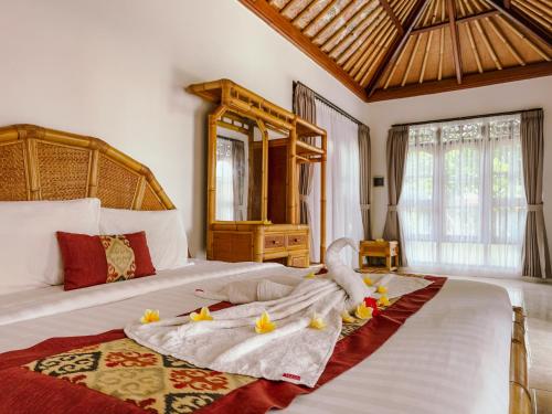 a bedroom with a large bed with flowers on it at Narafa's Guest House in Jasri