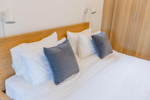 a white bed with two pillows on top of it at Sleep With Sheep - 3 Bedroom Pool Villa in Chiang Mai