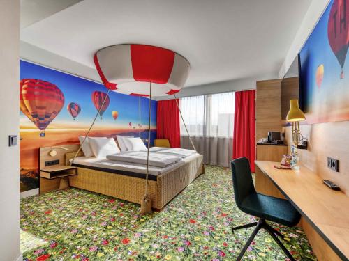 a bedroom with a bed with a balloon wall at Mercure Neu-Isenburg in Neu Isenburg