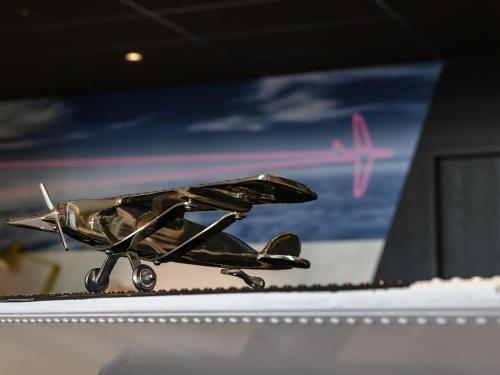 a small toy plane sitting on top of a shelf at Mercure Neu-Isenburg in Neu Isenburg