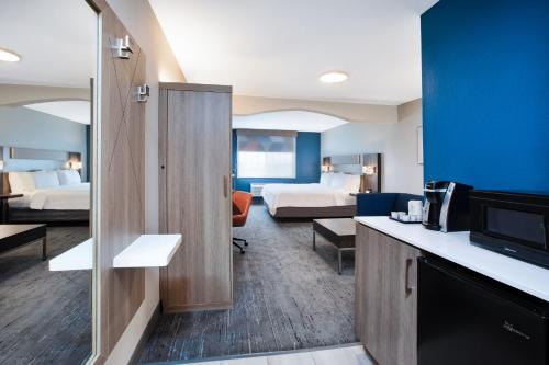 a hotel room with two beds and a television at Holiday Inn Express Hotel & Suites Defiance by IHG in Defiance