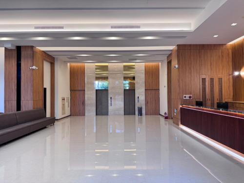a hospital hallway with a lobby with wooden walls and a waiting room at Mille Rich Hotel in Taitung City