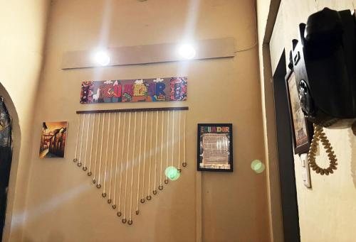 a room with a wall with a metal door with lights at INTI Entire apartment and private terrace in Quito