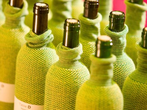 a group of green glass bottles are lined up at Mercure Hotel Hamburg Mitte in Hamburg