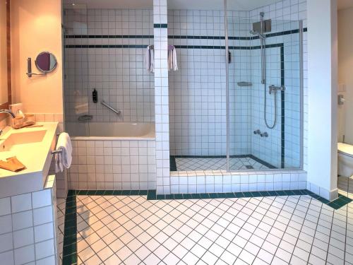 a bathroom with a shower and a sink at Mercure Tagungs- & Landhotel Krefeld in Krefeld