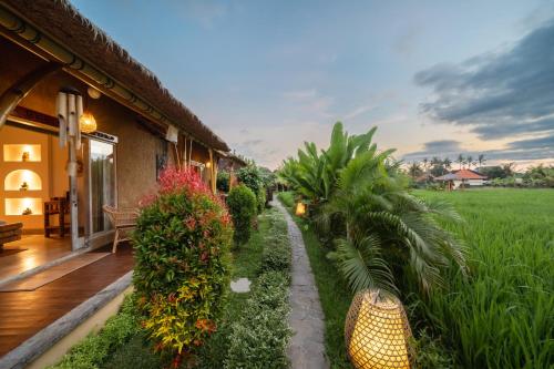 a house with a garden and a porch at Rumah Kita Ecolodge in Ubud