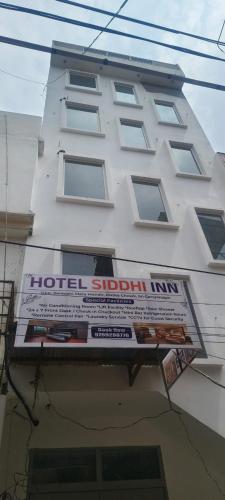 a building with a hotel scholar inn sign on it at Siddhi inn in Gangānagar