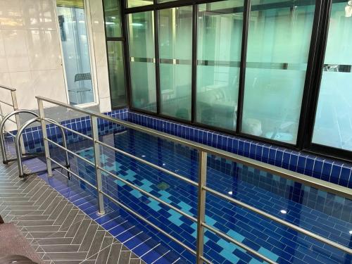 a swimming pool with blue tiles in a building at Gapyeong The Haru Emotional Pool Villa in Mŏk-kol