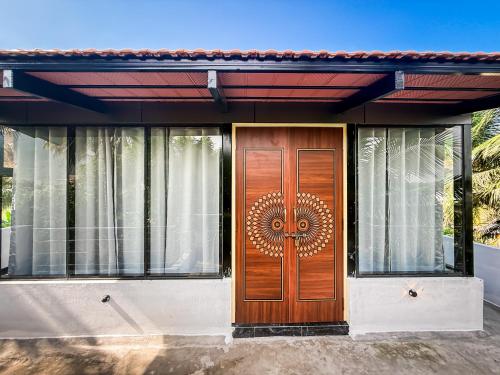 a house with a wooden door with a mandala on it at NAKSHATHRA Guest House 2BHK in Tiruvannāmalai