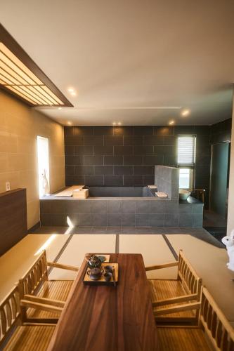 a room with a table and chairs and a couch at Ryokan Hotel Usagi in Chuncheon