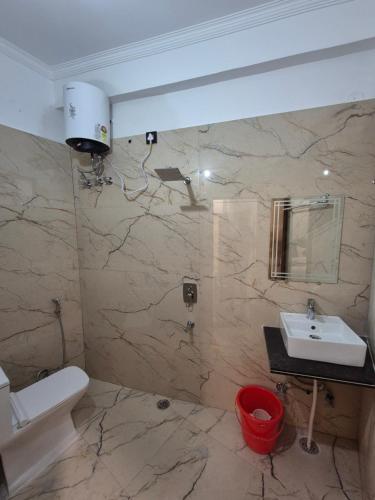 a bathroom with a sink and a toilet at Siddhi Retreat hotel in Rishīkesh