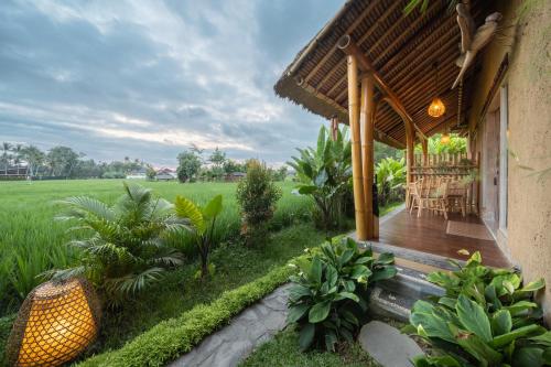 a porch of a house with a wooden deck at Rumah Kita Ecolodge in Ubud