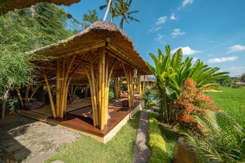 a small hut with a thatched roof at Rumah Kita Ecolodge in Ubud