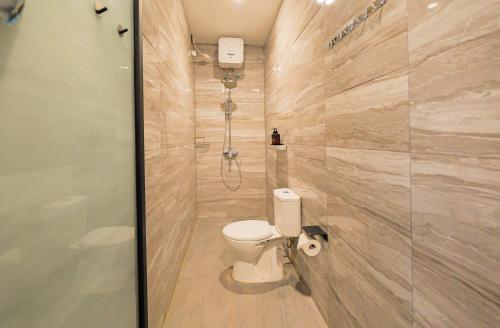 a bathroom with a toilet and a shower at 4BR Modern Villa walking dist to Sidewalk Jimbaran in Jimbaran