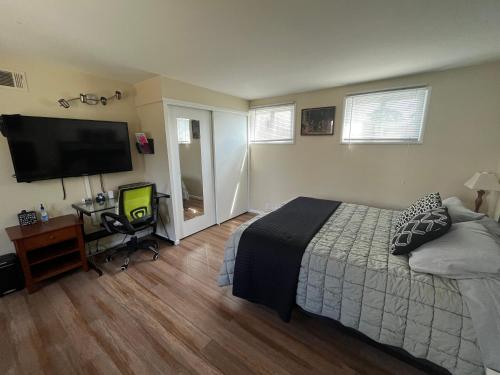 a bedroom with a bed and a flat screen tv at 2 Bedroom House OR Private Studio near SF, SFSU and SFO in Daly City