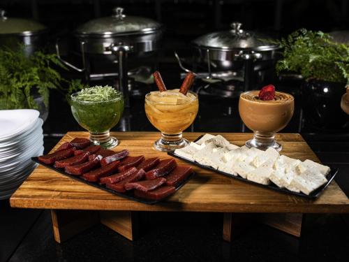 a table with meat and cheese and some drinks at ibis Betim in Betim