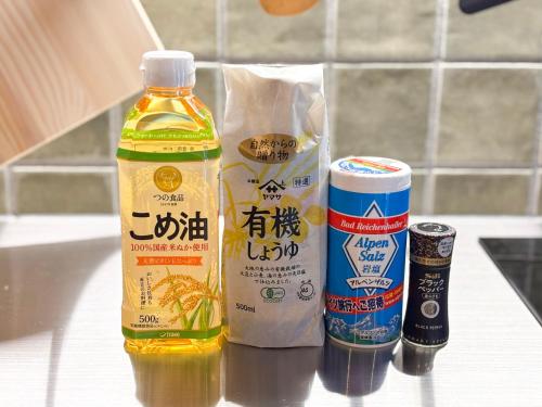 a bottle of oil and a container of food on a counter at 椿とことは in Obama