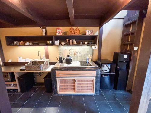 a small kitchen with a sink and a stove at 椿とことは in Obama
