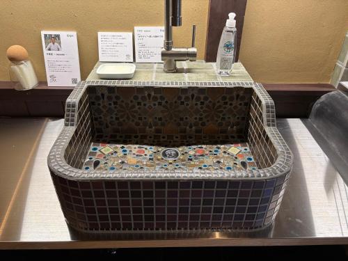 a bathroom sink with a faucet in a store at 椿とことは in Obama