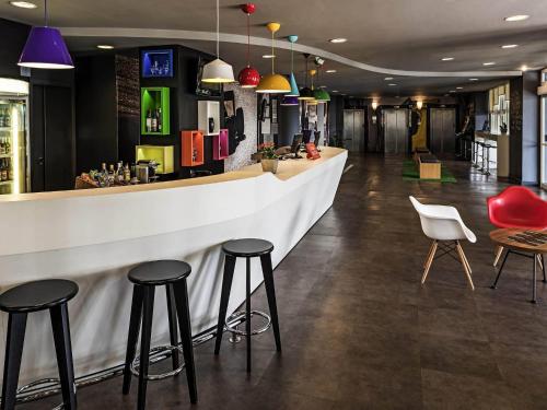 a bar in a restaurant with stools at ibis Sao Paulo Interlagos in Sao Paulo