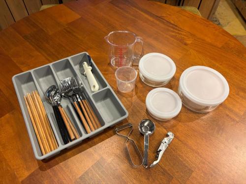 a tray of utensils sitting on top of a wooden table at 葉山ヒュッゲ in Hayama