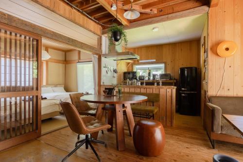 a room with a table and a bed and a bedroom at 葉山ヒュッゲ in Hayama