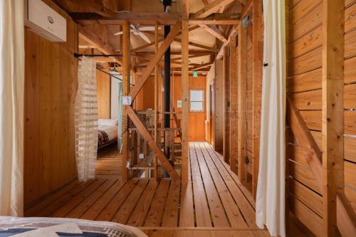 a room with wooden walls and a staircase in a house at 葉山ヒュッゲ in Hayama