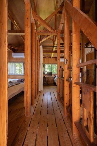 a large room with wooden floors and wooden beams at 葉山ヒュッゲ in Hayama