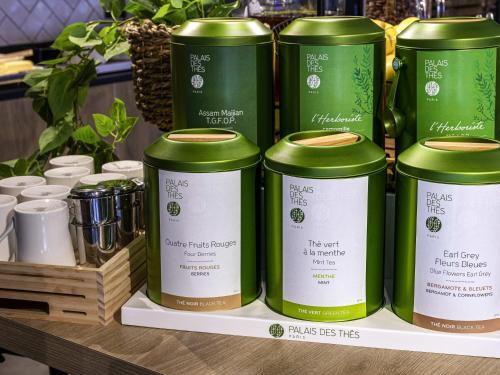 a group of green cans sitting on a shelf at ibis La Ciotat in La Ciotat