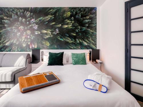 a bedroom with a bed with a tray on it at Novotel Luxembourg Centre in Luxembourg