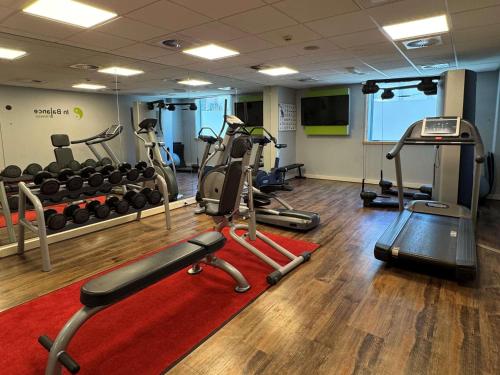 a gym with several treadmills and exercise bikes at Novotel Luxembourg Centre in Luxembourg