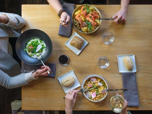 a group of people sitting around a table eating food at Novotel Luxembourg Centre in Luxembourg